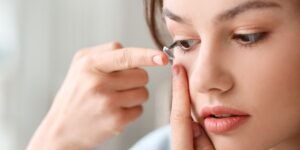 Woman putting on multifocal contact lenses
