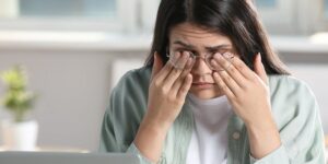 Woman scratching eyes - dry eye syndrome
