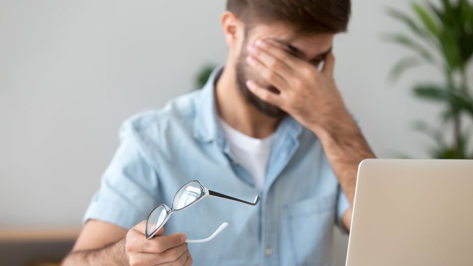 Michigan Contact Lens | Perfect Dry Eye Specialist in Birmingham MI: A 2025 Guide A man rubbing his tired eyes from digital eye strain, a symptom needing a dry eye specialist in Birmingham MI.